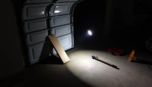 How can I temporarily secure my garage door before help arrives?